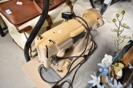 An electric Singer sewing machine with red badge