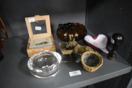 A selection of curios including an art glass pumpkin, a spelter donkey and a stamp head