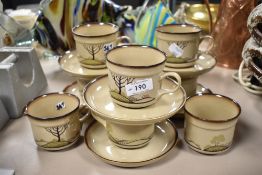 A selection of Denby Savoy tea cups and saucers with milk jug