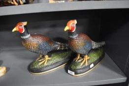 A pair of large cast iron pheasant design door stops