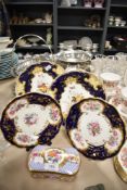 Four antique plates having cobalt blue ground with hand tinted floral patterns, also included is a