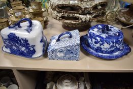 A blue and white Royal Doulton 'Oyama' cheese dome and two similar examples, one void of plate.