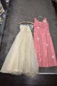 A pink 1960s maxi dress having daisy details and a 1950s lace Wedding dress, later slightly