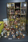 A selection of modern miniature figures and trinkets with a glass display case