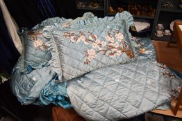 A vintage Chinese satin bedspread and pillow case set having extensive embroidery.
