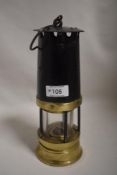 An antique coal or similar miners lamp having brass and iron case with no makers marks