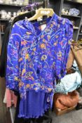 A 1980s collectable Diana Fres skirt and blouse set having bright pattern on purple ground.