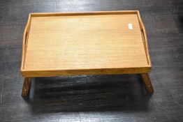 A vintage over bed tray having folding legs.