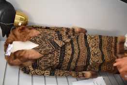 A 1930s wool coat having embroidery and fur collar and cuffs, single button to waist, silk lining