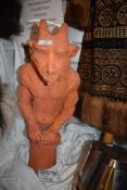 A late Victorian terracotta roof or ridge tile with a grotesque gargoyle figure perched atop