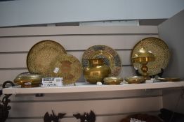 A selection of Indian brass wares including an antique plate with Hindu decoration