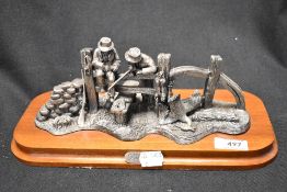 A cast metal study on mahogany plinth, Poachers