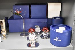 A selection of modern Swarovski silver crystal glass studies of flower baskets and flower with