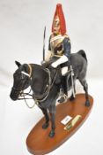 A Royal Doulton study, Blues and Royals, connoisseur horses, matt, on plinth, scabbard af