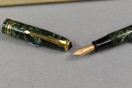 A Conway Stewart lever fill fountain pen in green hatched pattern with one broad and two narrow