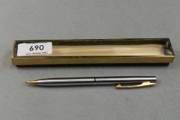 A boxed Sheaffer propelling pencil in brushed steel with gold trim and white spot