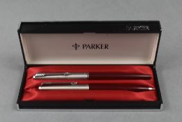 A Parker 45 fountain pen and ballpoint pen set in red in original box