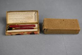 A Conway Stewart Dinkie 540 leverfill fountain pen and propelling pencil set in pink having original