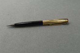 A Parker propelling pencil in black with gold cap