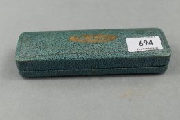 A Parker Slimfold fountain pen and propelling pencil set in green with single decorative band to cap