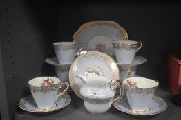 A partial Collingwood tea service, having pale blue ground, gilt motifs and floral design.