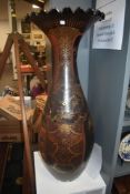 An impressive late 19th/early 20th century black and gilt Japanese vase having decoration of storks,