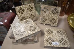 Six late 19th early 20th century Minton floor tiles having black and beige motifs to cream ground,