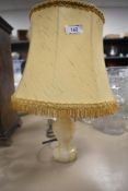 A vintage table top lamp having Onyx stone turned base with original shade
