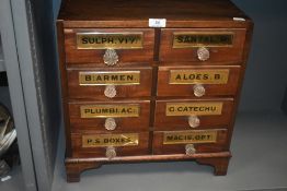 A late Victorian shop counter apothecary or similar storage chest in mahogany with glass handles and