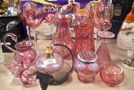 A selection of cranberry glass, including perfume bottles, vases and glasses.