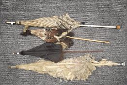 A selection of late Victorian sun parasols including lace worked with bamboo effect handle