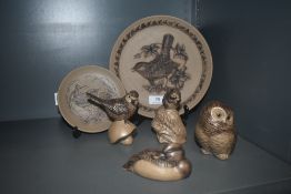 A selection of Poole pottery in a brown glaze including animal studies and plates