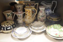A large collection of Art Deco era ceramics including jugs, vases, rose bowls and dishes