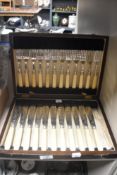 A canteen of fish cutlery having chase worked designs in a mahogany case