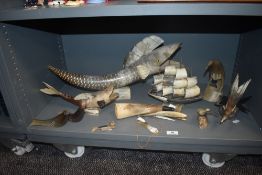 A selection of 20th century horn carved items including sailing ship, large fish figure, birds and