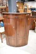 A 19th Century mahogany bow front corner cupboard