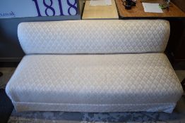 A traditional upholstered daybed