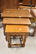 A traditional nest of three oak tables
