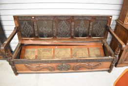 A composite part period oak and mahogany box settle having panel back, parquet seat and applique