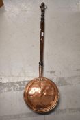 A traditional copper warming pan