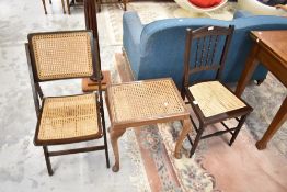A cane seated stool, bedroom chair and similar folding chair