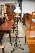 A Victorian cast standard oil lamp having copper and brass fittings and opaque glass shade
