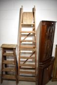 A large set of wooden stepladders