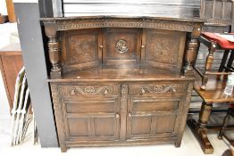 A Priory style court cupboard having recessed top centre section