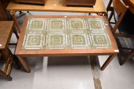 A vintage teak and textured tile top coffee table