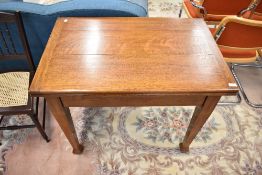 An early 20th Century oak fold over dining table