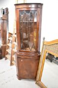 A reproduction mahogany glazed double corner cupboard. 179CM.