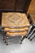 An early 20th nest of three walnut tables