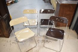 A set of four vintage folding chrome and plastic chairs