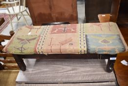 A stained frame footstool, with fabric covering